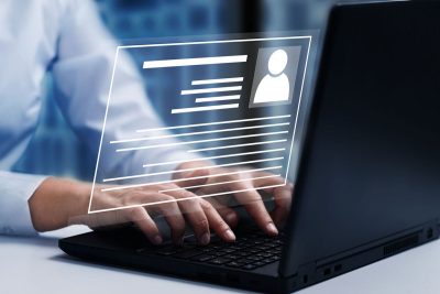 hands typing on laptop with bio illustratoin