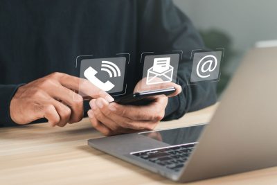 hand typing on phone with contact icons